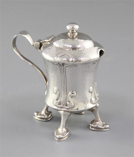 An Edwardian Arts and Crafts Cymric silver mustard pot, designed by Archibald Knox, for Liberty & Co, numbered 409, height 70mm,